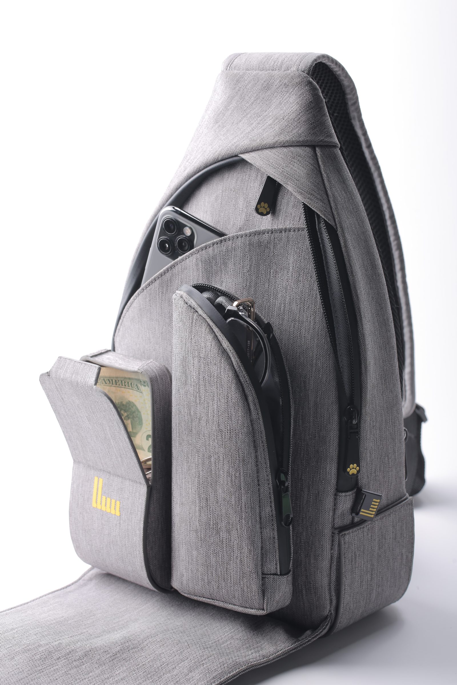 SixWalker Sling flat lay with wallet, phone, and sunglasses